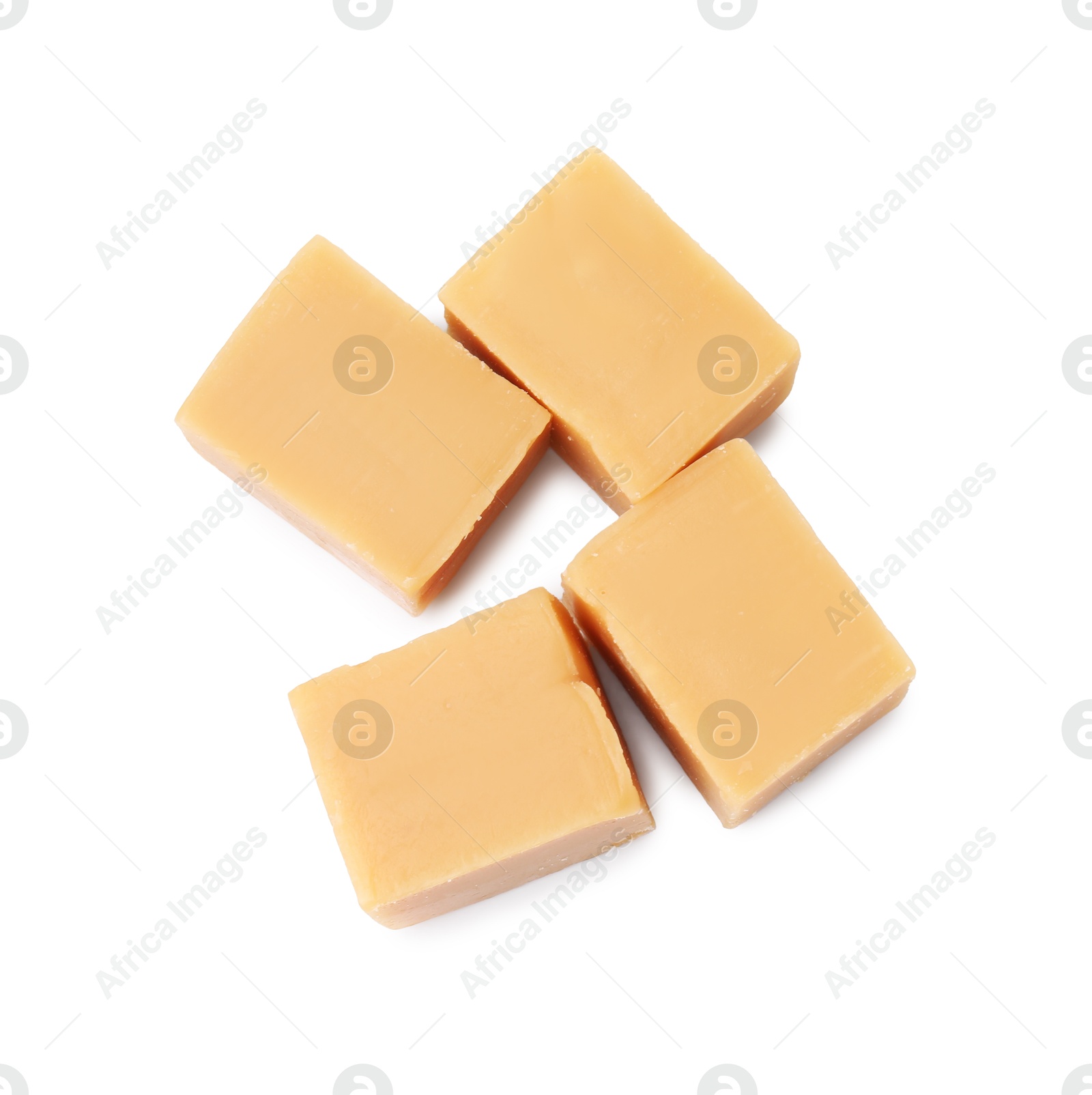 Photo of Tasty sweet caramel candies isolated on white, top view