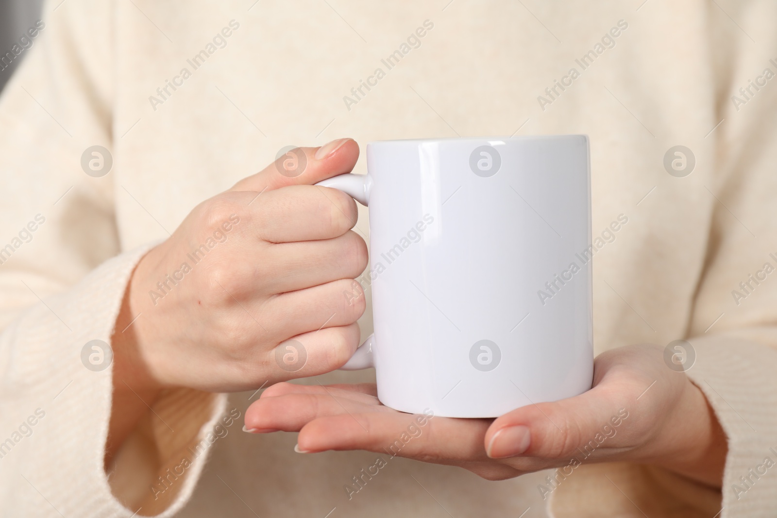 Photo of Woman with white ceramic cup, closeup. Mockup for design