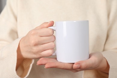 Photo of Woman with white ceramic cup, closeup. Mockup for design