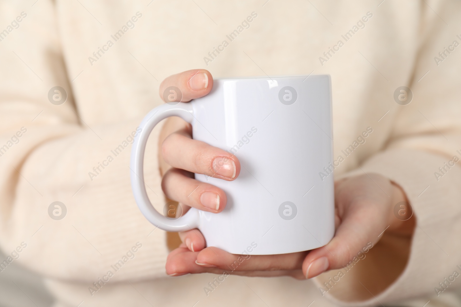 Photo of Woman with white ceramic cup, closeup. Mockup for design