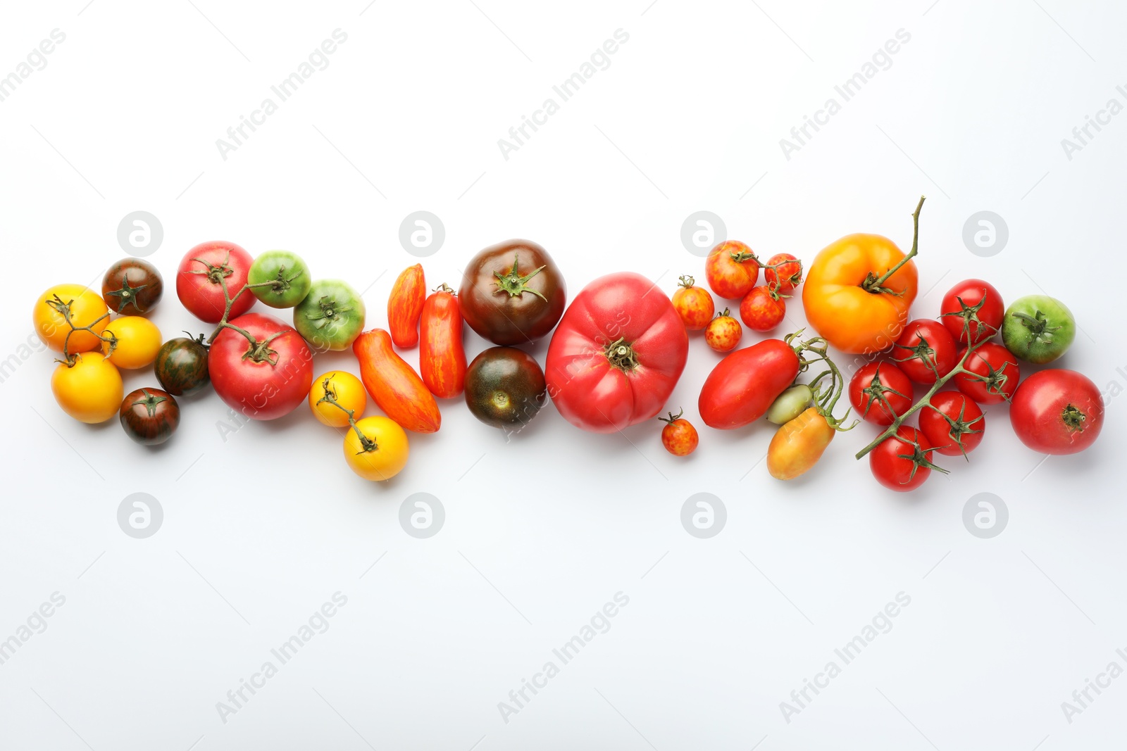 Photo of Different ripe tomatoes on white background, flat lay