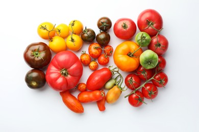 Photo of Different ripe tomatoes on white background, flat lay