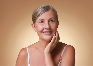 Face massage. Beautiful woman with healthy skin on beige background