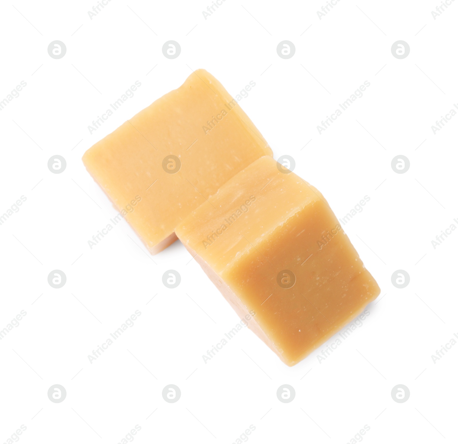 Photo of Tasty sweet caramel candies isolated on white, top view