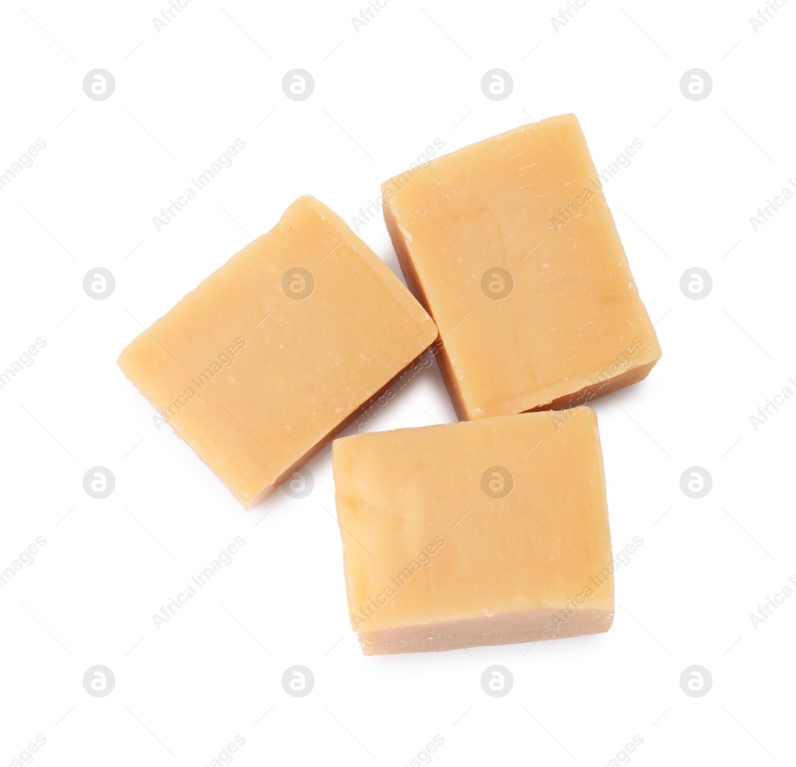 Photo of Tasty sweet caramel candies isolated on white, top view