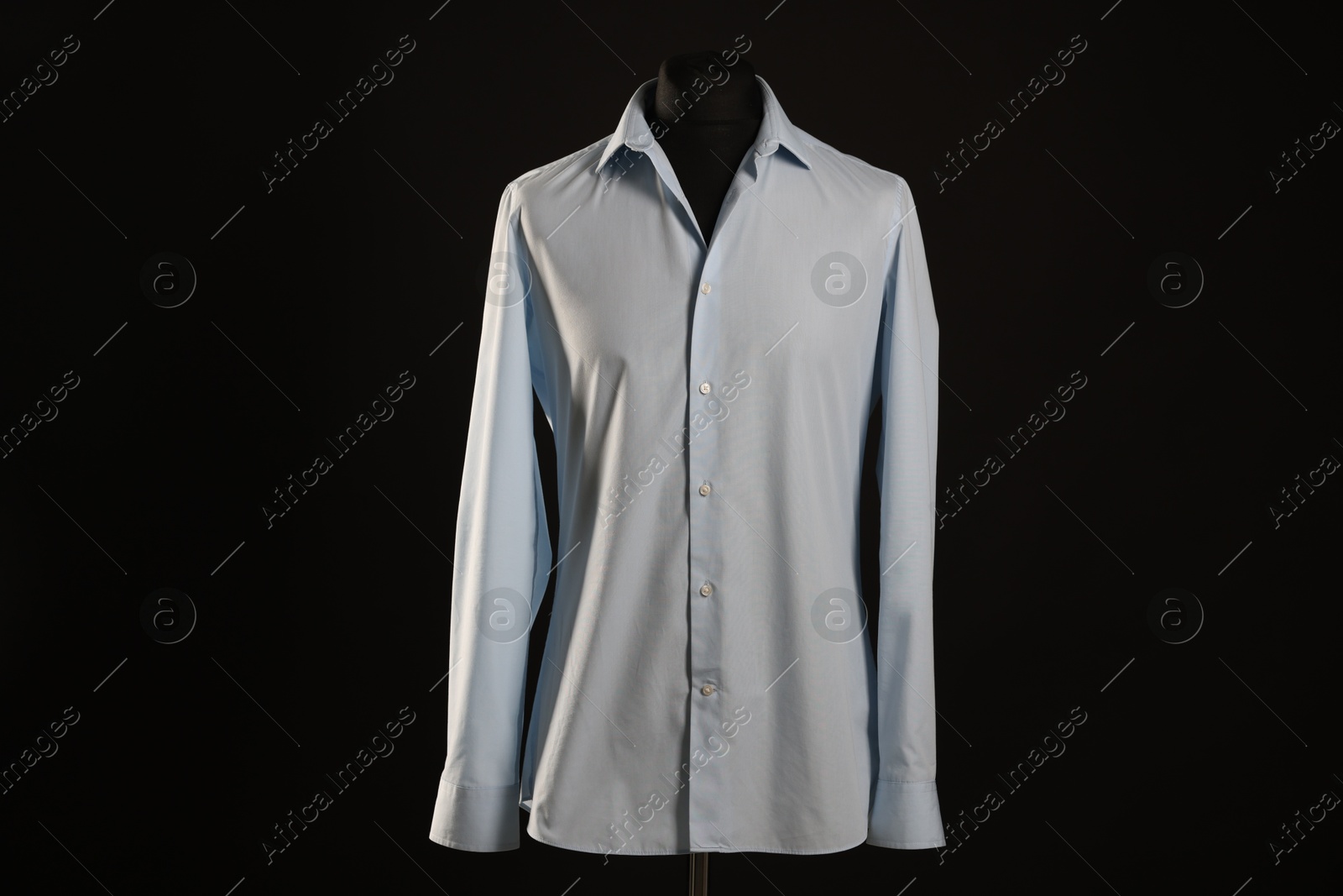 Photo of Male mannequin with white shirt on black background