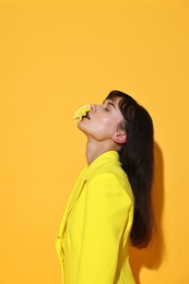 Photo of Woman with beautiful flower on yellow background