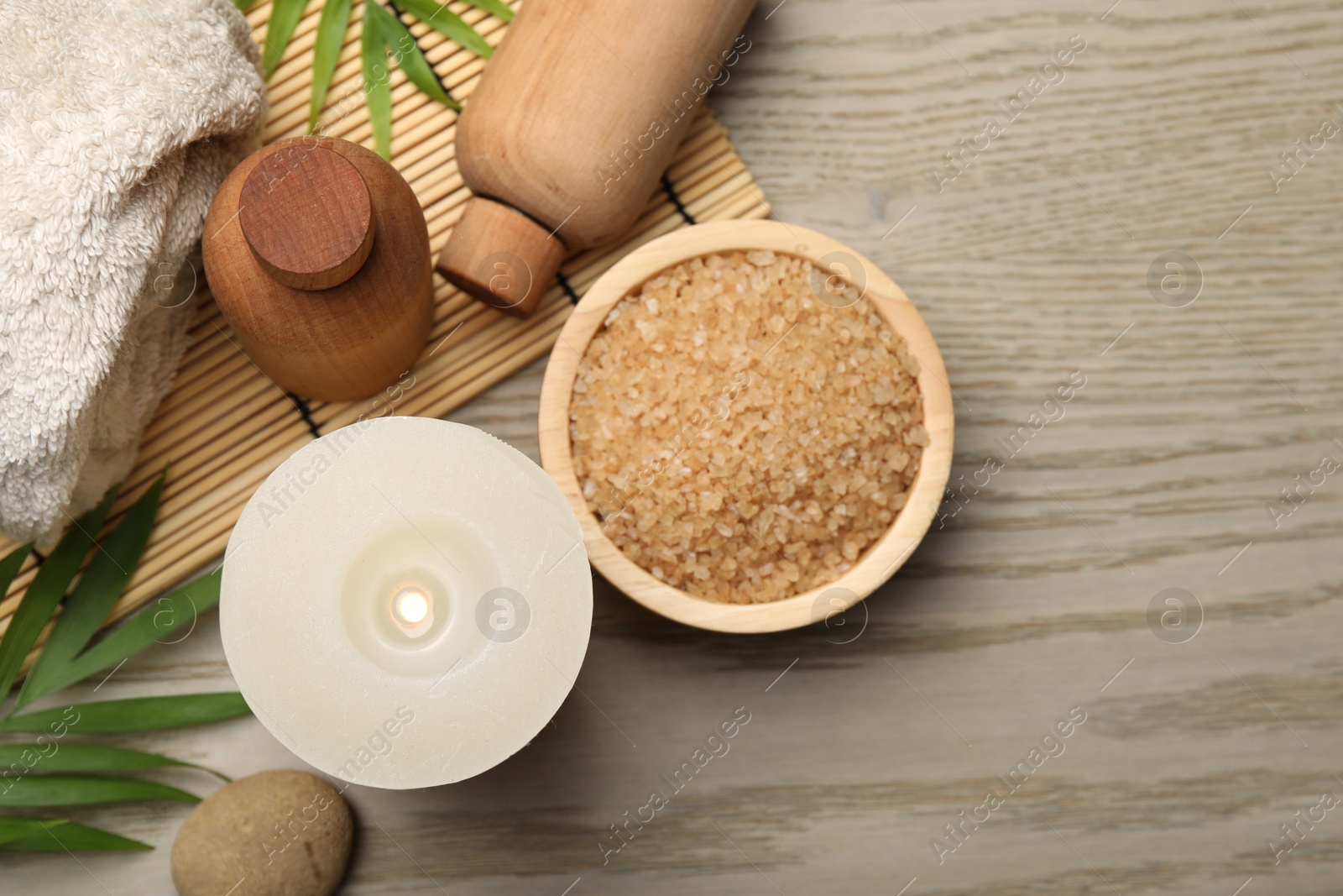 Photo of Spa composition with burning candle on wooden table, flat lay