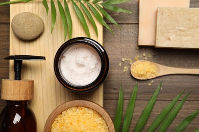 Spa composition with different cosmetic products on wooden table, flat lay