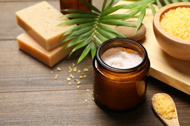 Photo of Spa composition with different cosmetic products on wooden table, closeup