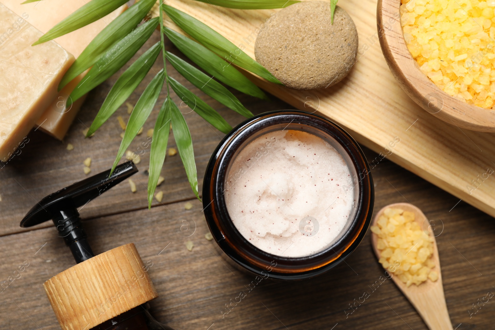 Photo of Spa composition with different cosmetic products on wooden table, flat lay