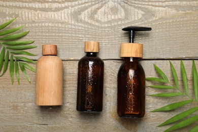 Photo of Spa composition with different cosmetic products on wooden table, flat lay