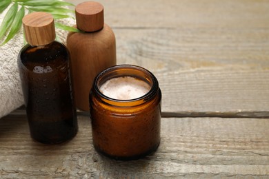 Spa composition with different cosmetic products on wooden table, closeup. Space for text