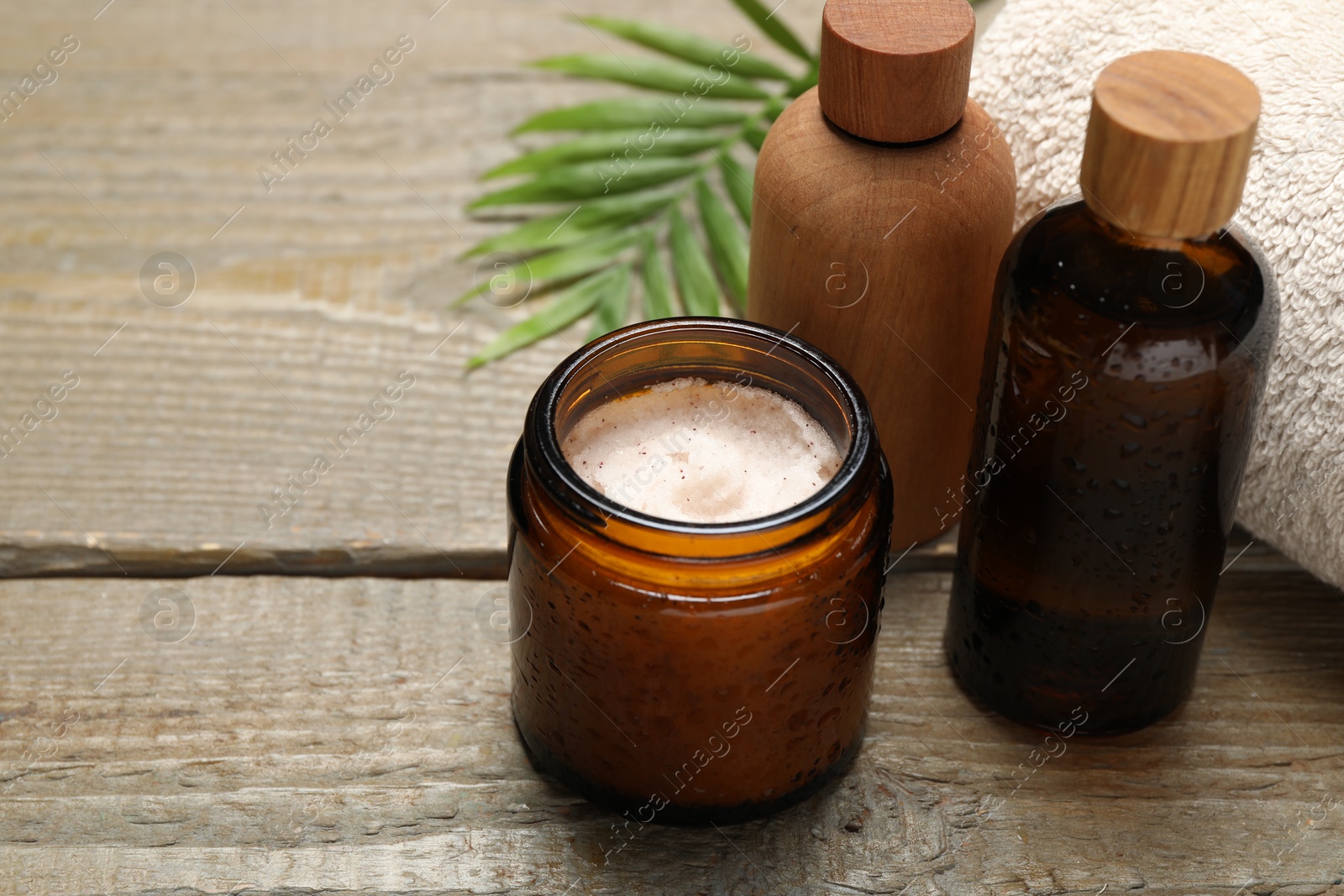 Photo of Spa composition with different cosmetic products on wooden table, closeup. Space for text