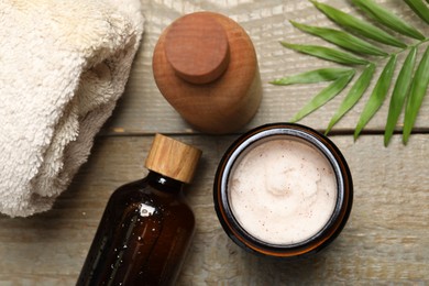 Spa composition with different cosmetic products on wooden table, flat lay