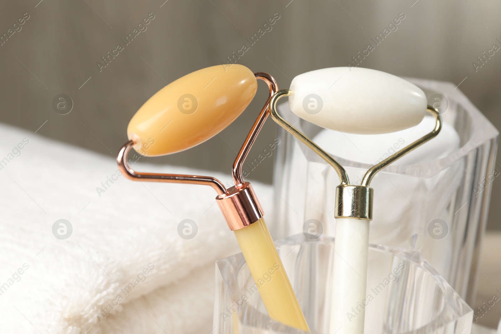 Photo of Face rollers in glass holder on table, closeup