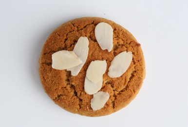 Photo of One tasty cookie with almond flakes on white background, top view