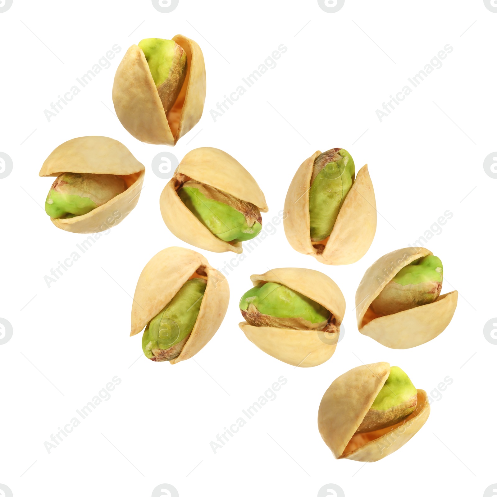 Image of Tasty pistachios in air on white background