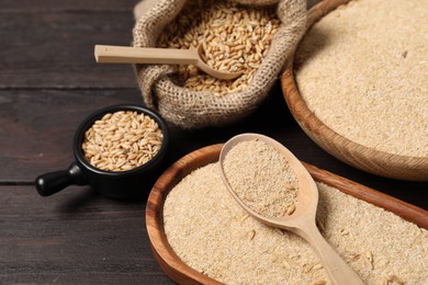 Photo of Oat bran and grains on wooden table, closeup