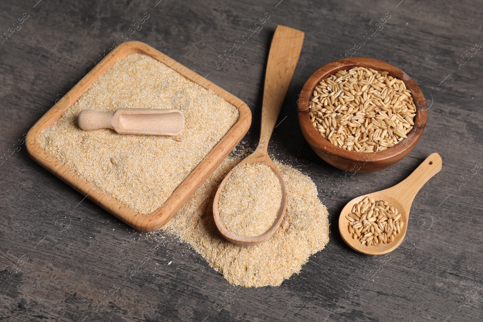 Photo of Oat bran and grains on grey table