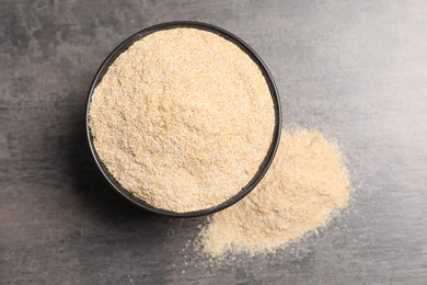 Photo of Oat bran in bowl on grey table, top view