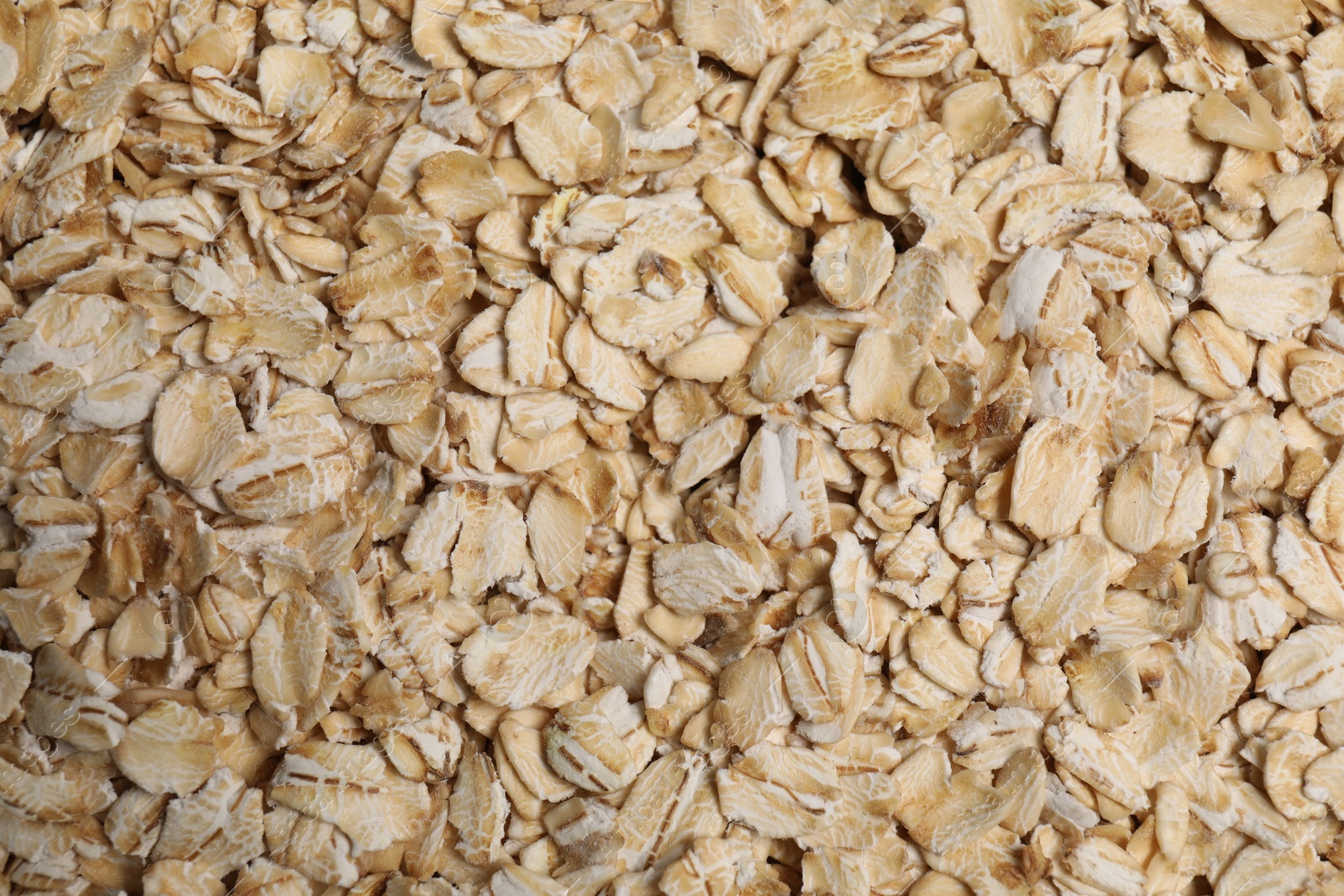 Photo of Pile of oat flakes as background, top view