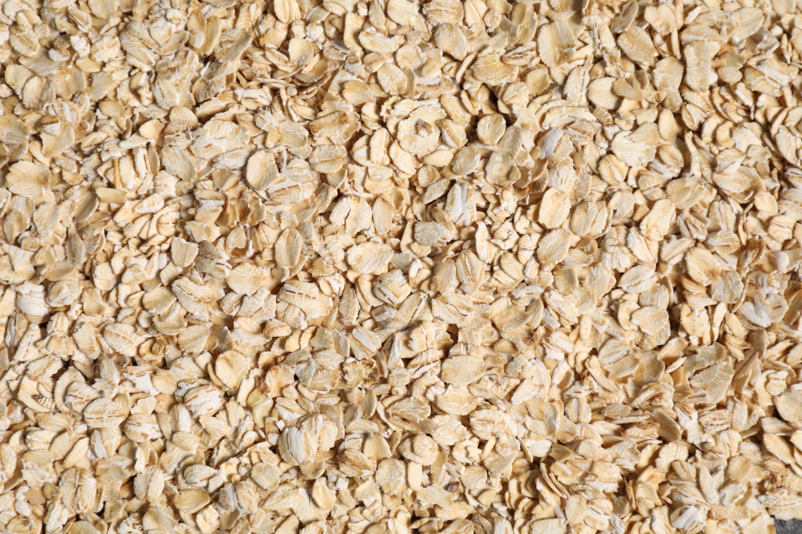 Photo of Pile of oat flakes as background, top view