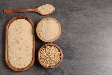 Photo of Oat bran and grains on grey table, flat lay. Space for text