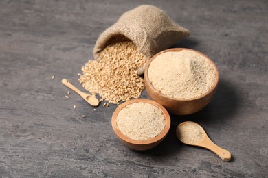 Oat bran and grains on grey table