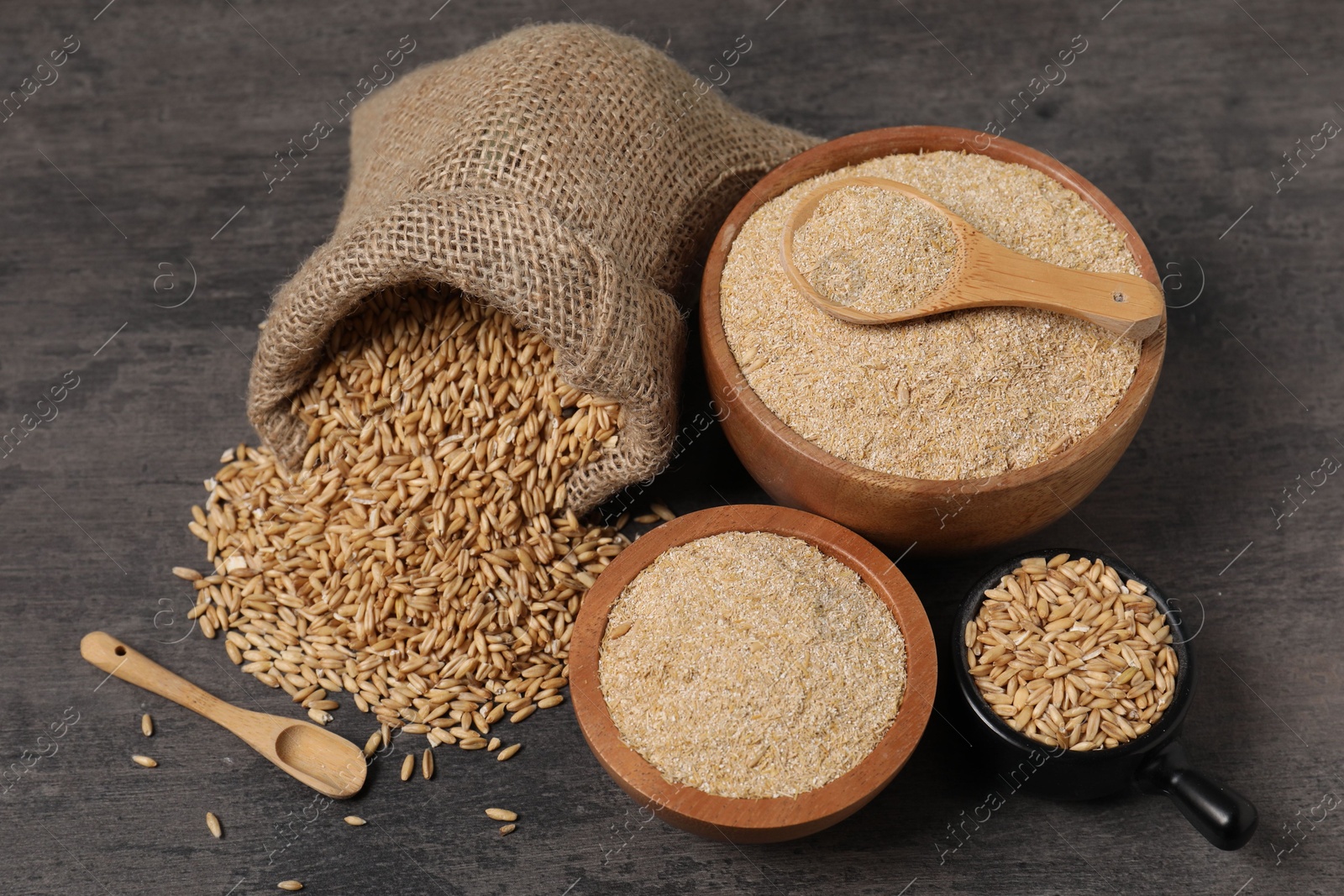 Photo of Oat bran and grains on grey table