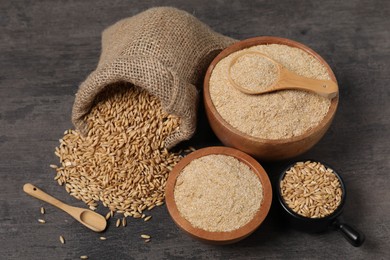 Photo of Oat bran and grains on grey table