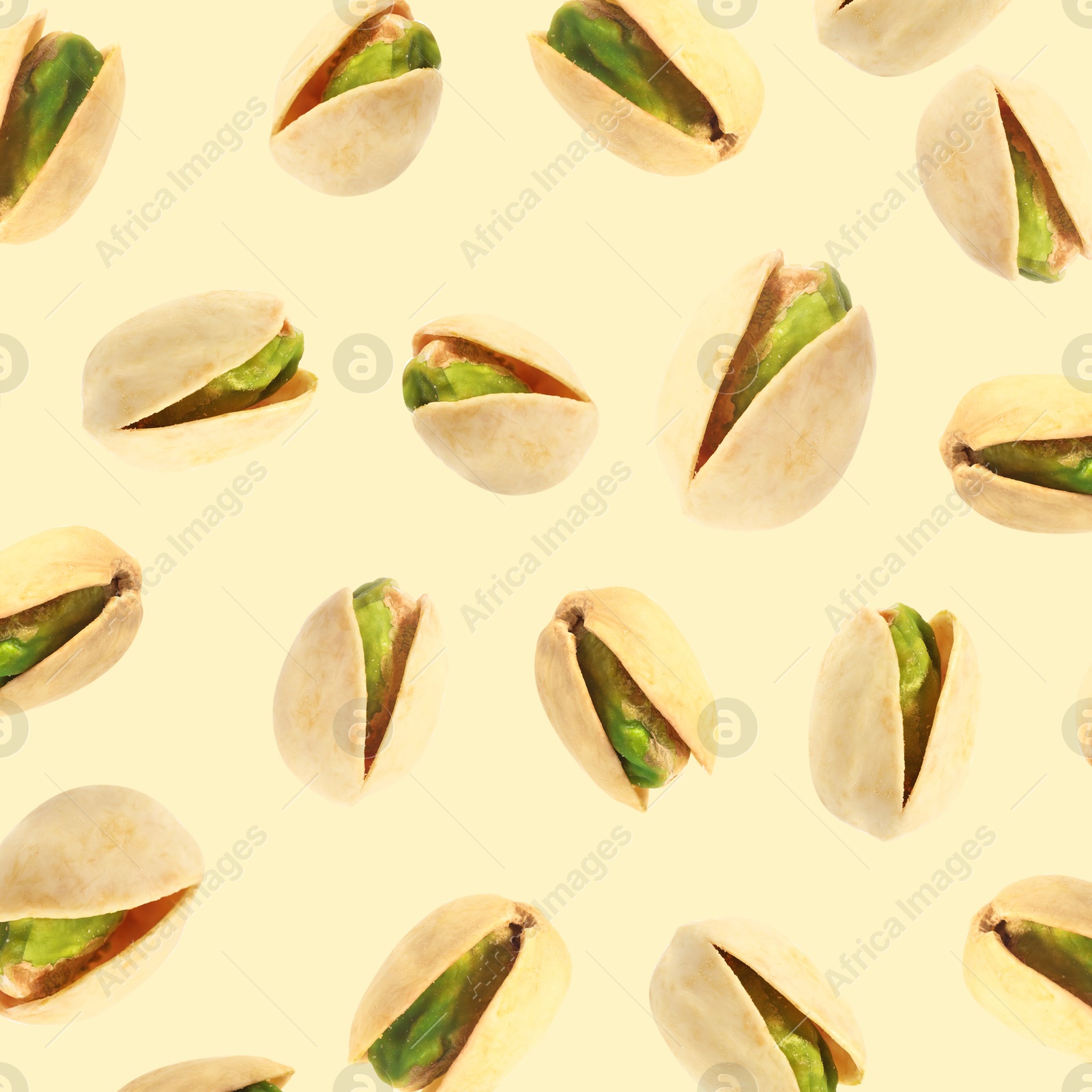 Image of Tasty pistachios in air on color background