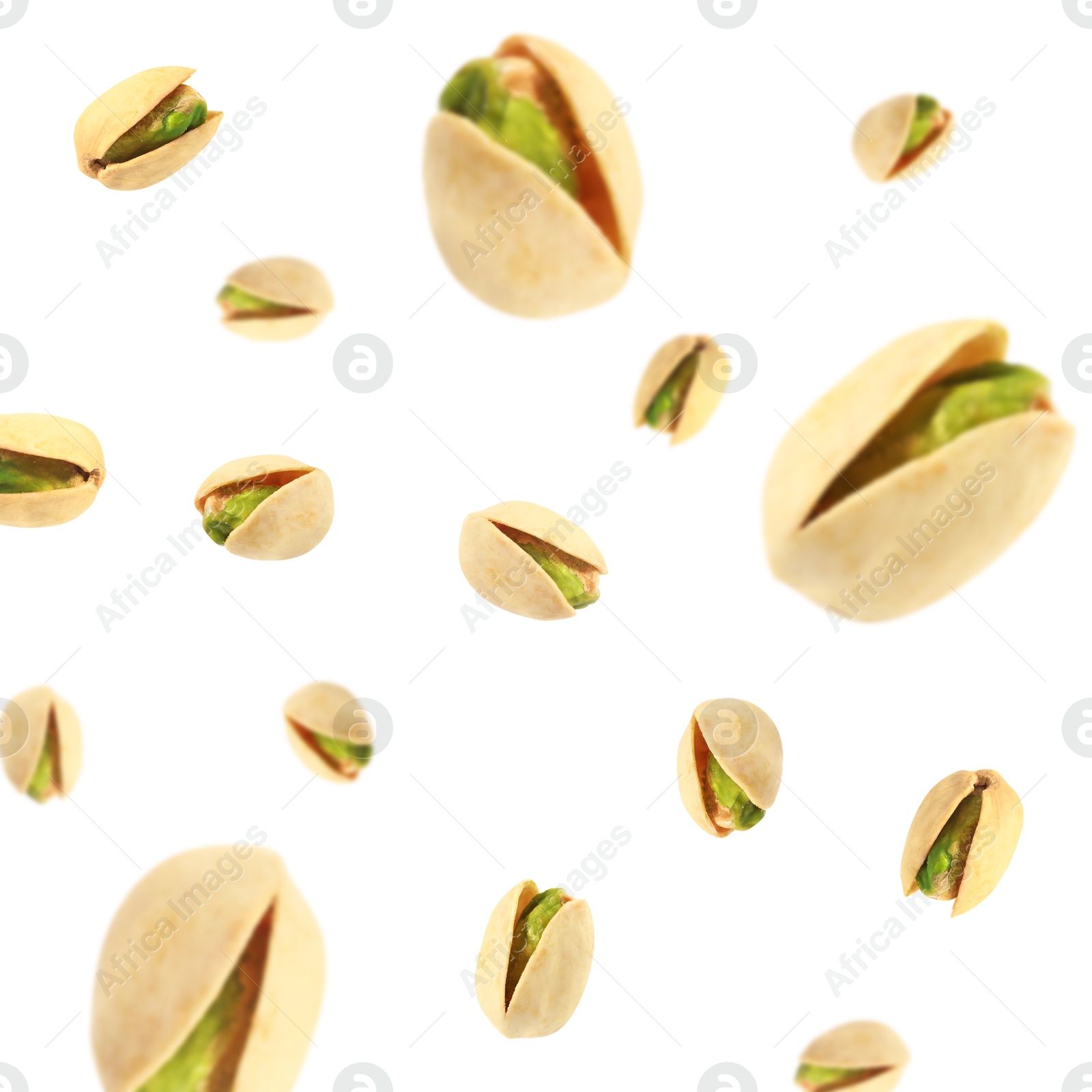 Image of Tasty pistachios in air on white background