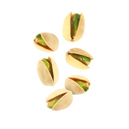 Tasty pistachios in air on white background