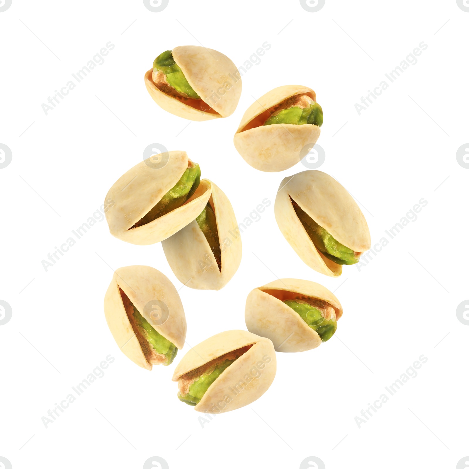 Image of Tasty pistachios in air on white background