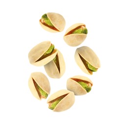 Image of Tasty pistachios in air on white background