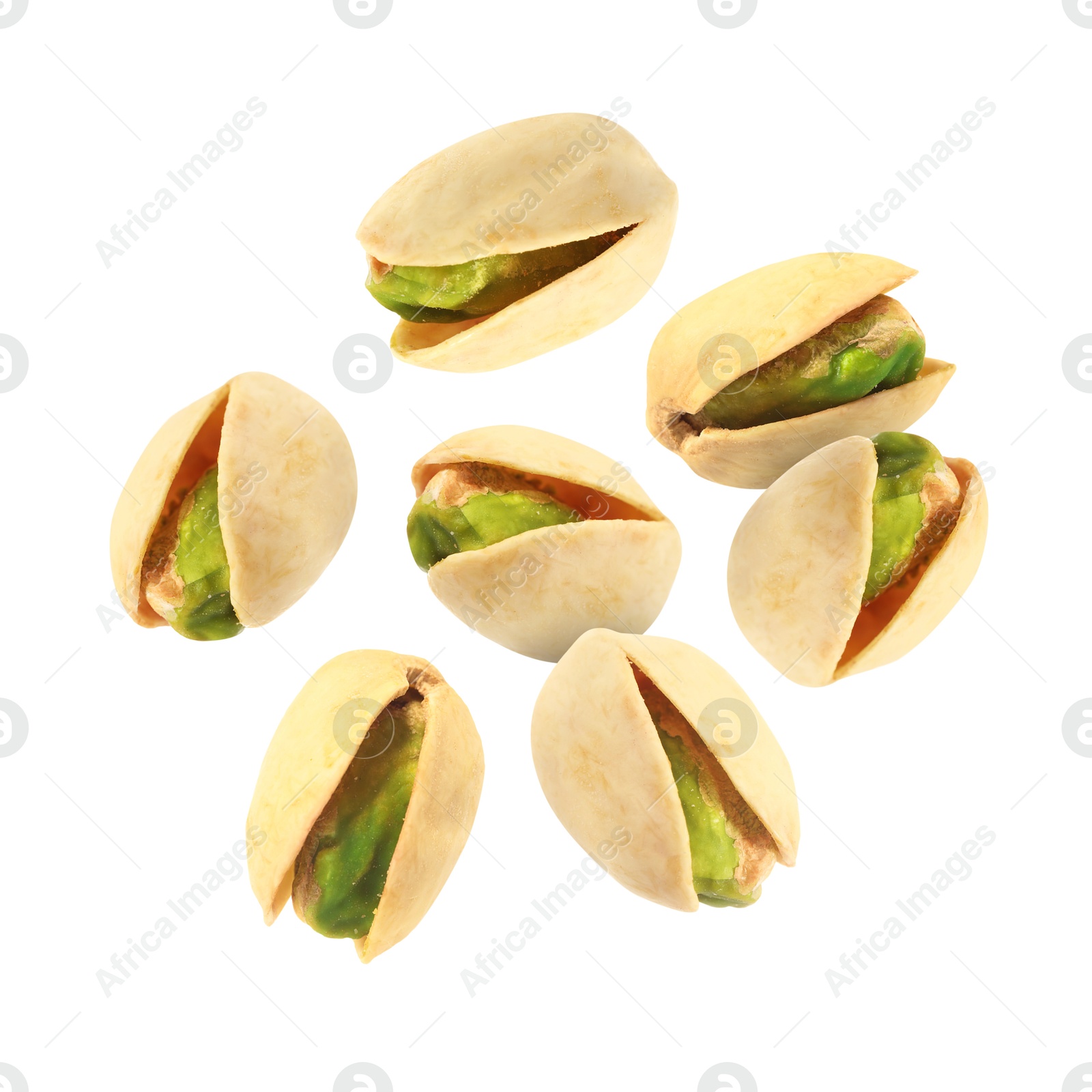 Image of Tasty pistachios in air on white background