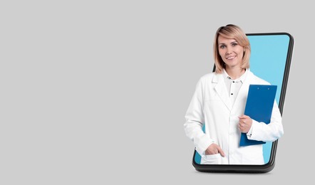 Image of Online medical consultation. Doctor with clipboard on smartphone screen against light grey background. Banner design with space for text