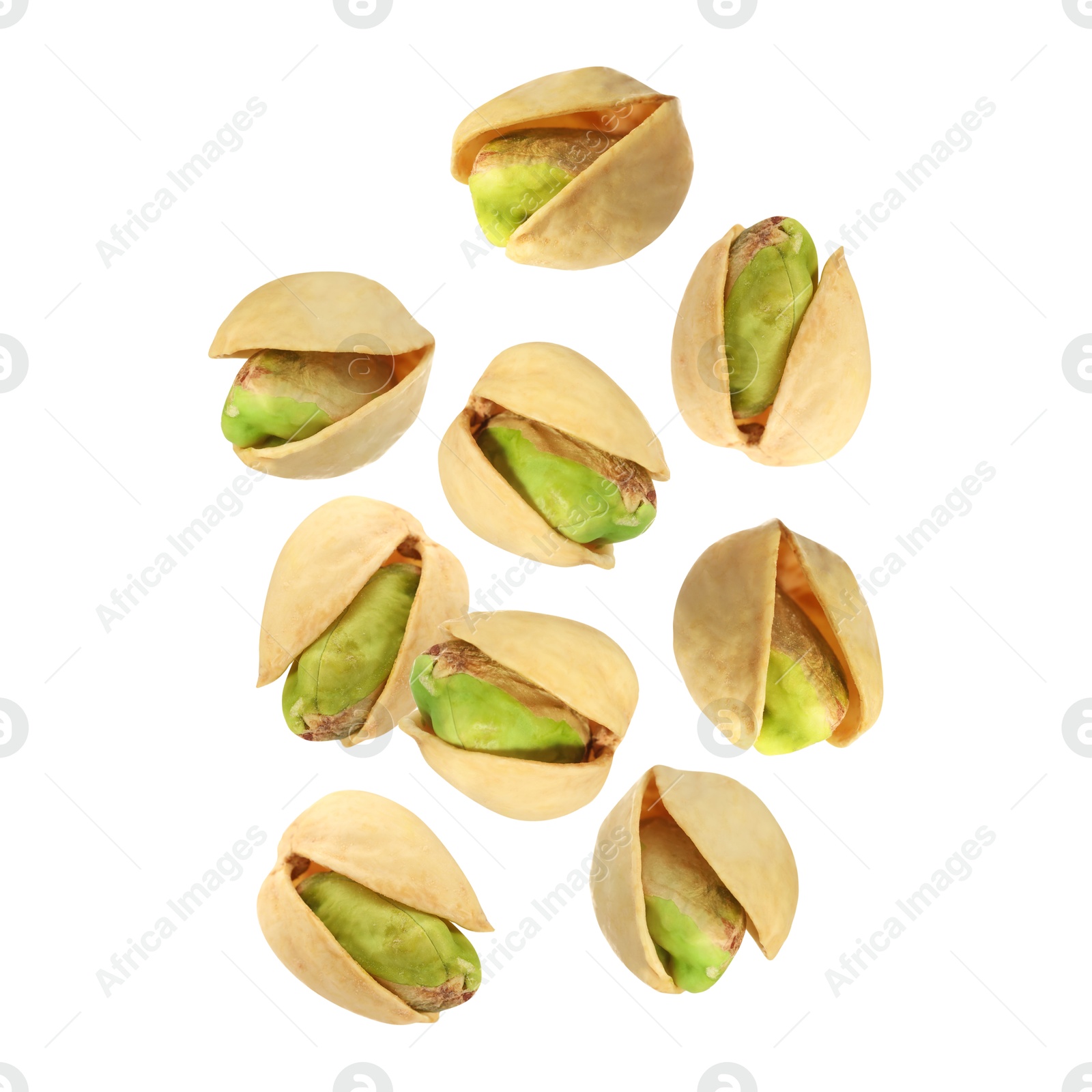 Image of Tasty pistachios in air on white background