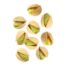 Image of Tasty pistachios in air on white background