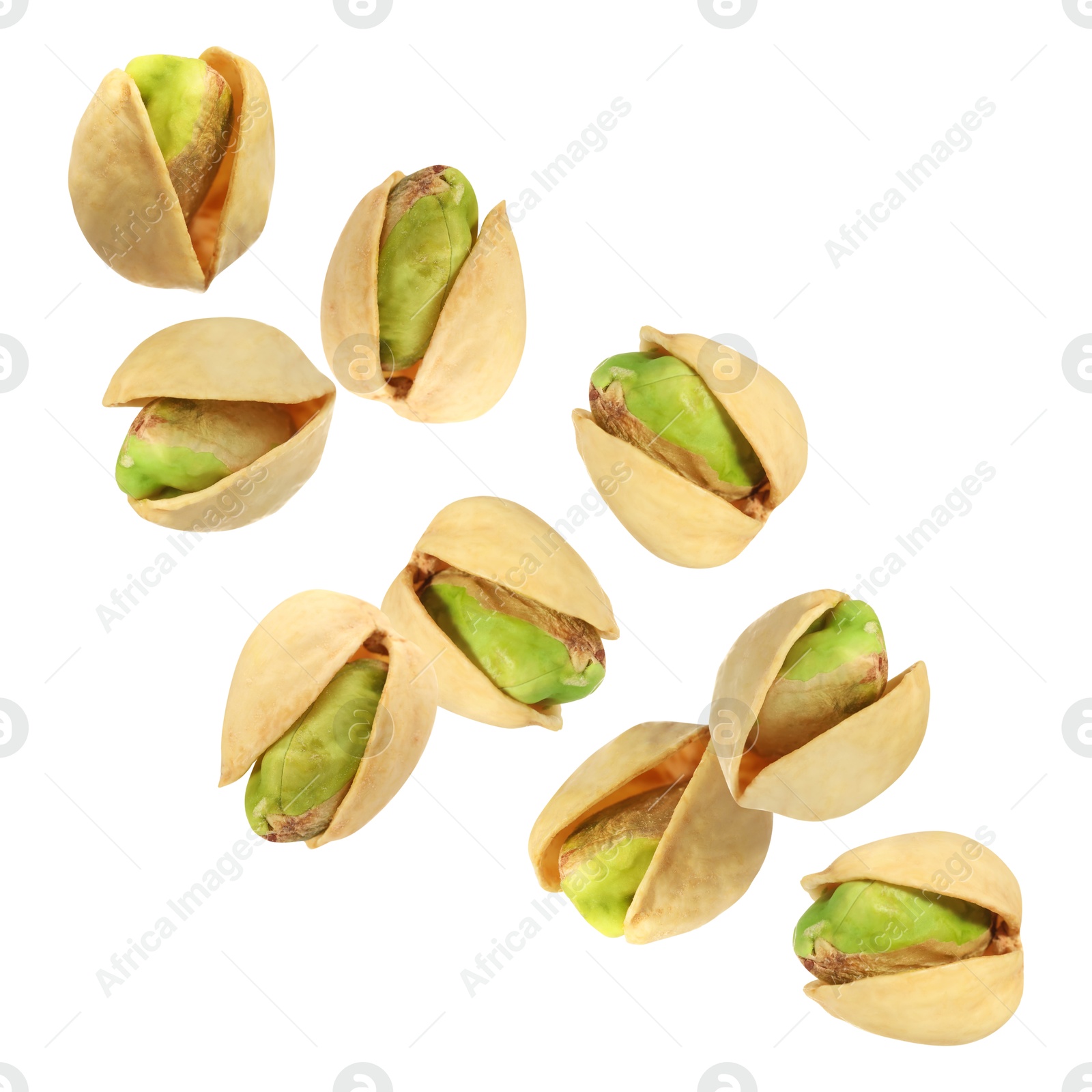 Image of Tasty pistachios in air on white background