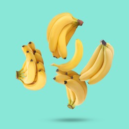 Image of Many yellow bananas falling on turquoise background