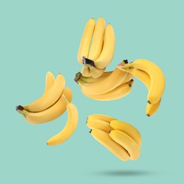 Image of Many yellow bananas falling on turquoise background