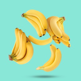 Image of Many yellow bananas falling on turquoise background