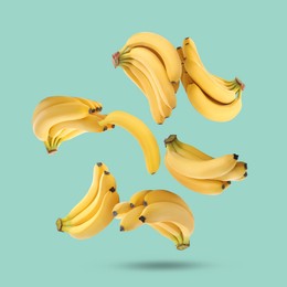 Image of Many yellow bananas falling on turquoise background