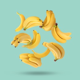 Image of Many yellow bananas falling on turquoise background