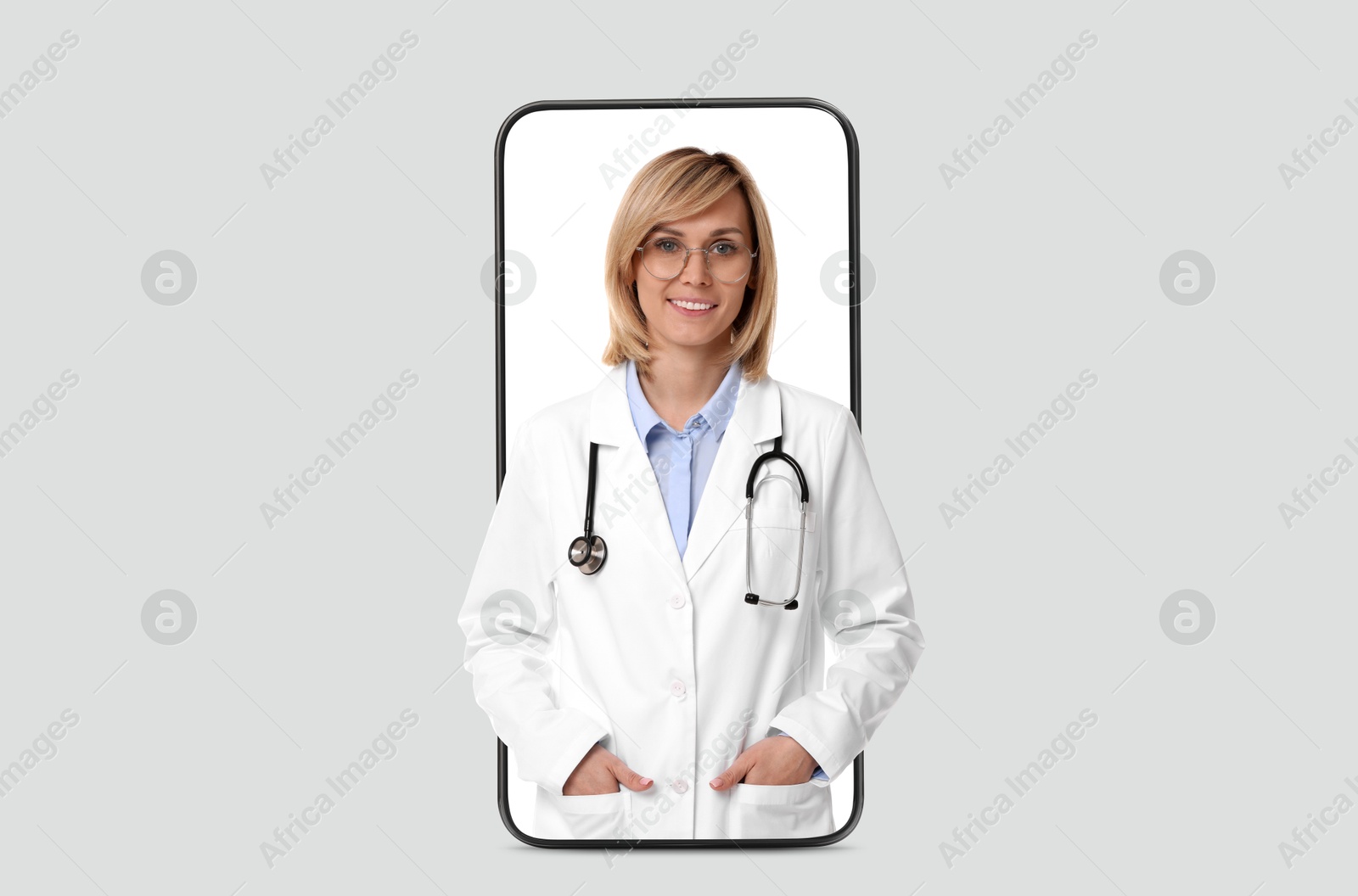 Image of Online medical consultation. Doctor on smartphone screen against light grey background