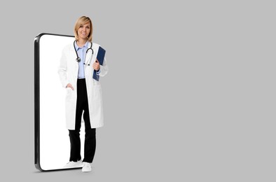 Image of Online medical consultation. Doctor with clipboard on smartphone screen against light grey background, space for text