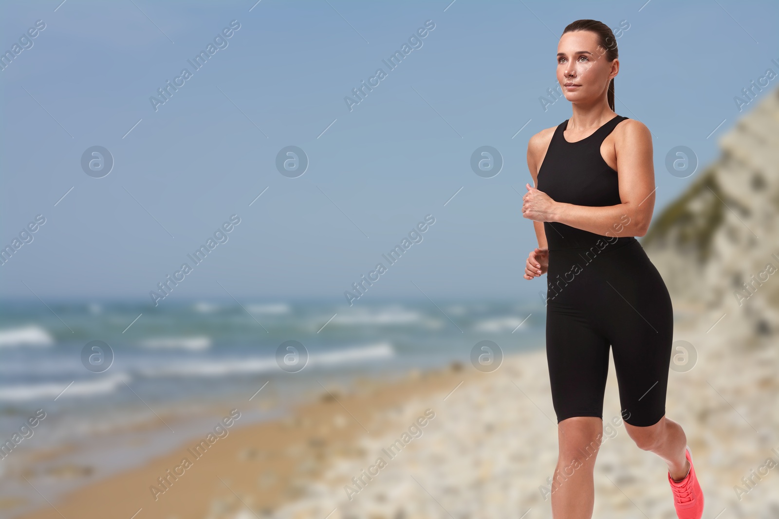 Image of Beautiful woman running on beach. Space for text