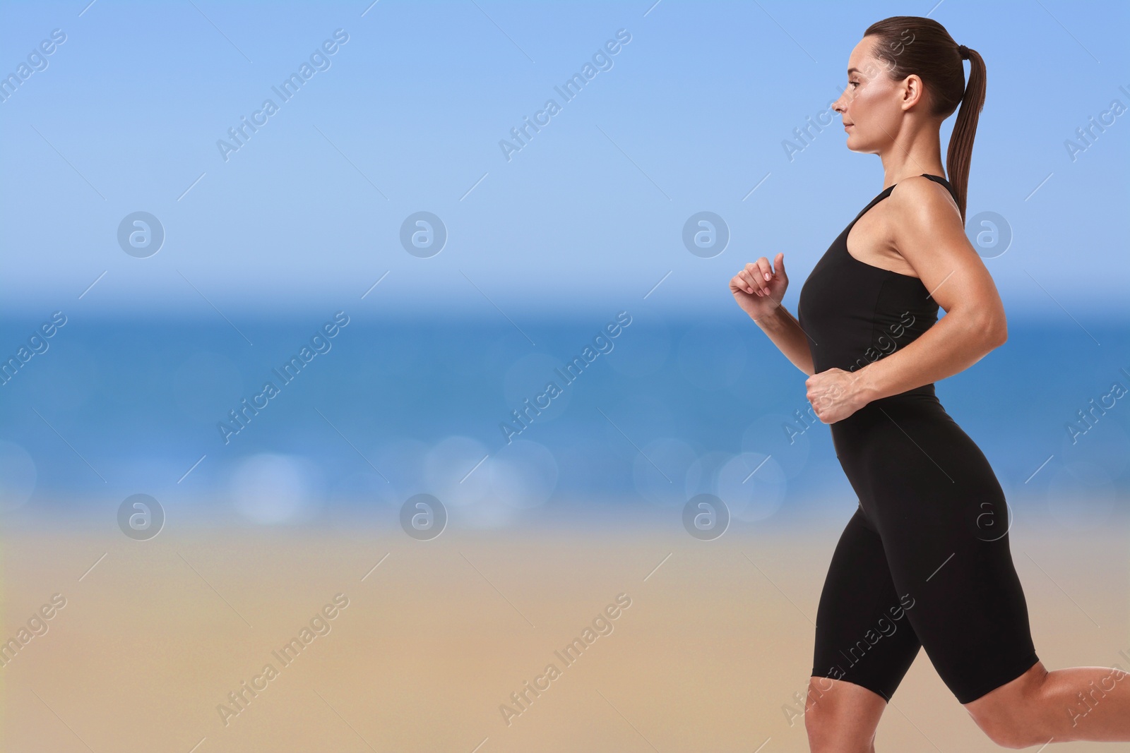 Image of Beautiful woman running on beach. Space for text